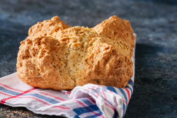 Freshly baked cheesy spinach bread on a white stone backdrop. Rustic style.