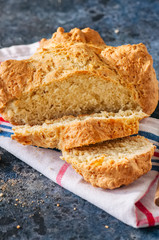 Freshly baked cheesy spinach bread on a white stone backdrop. Rustic style.