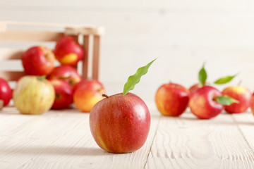Red apples in a light wooden box