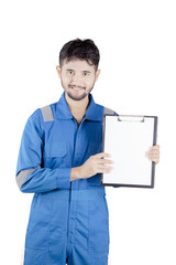 Young friendly mechanic holding clipboard with copy space