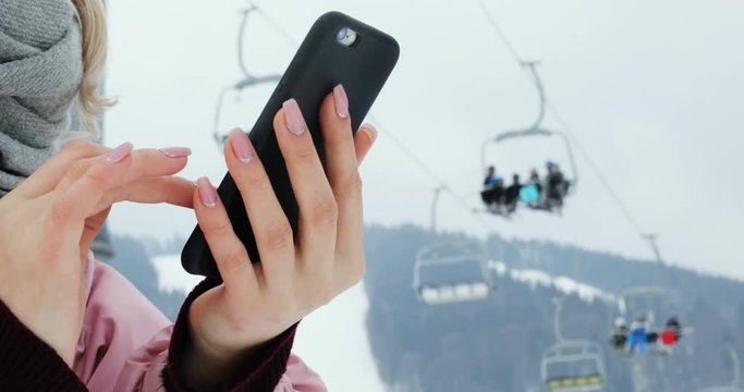 closeup woman hands using digital modern smart phone outside winter mountains ski lift background nature beautiful landscape internet connect tapping scrolling touching screen business typing flipping