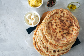 Freshly baked cheesy spinach bread on a white stone backdrop. Rustic style.