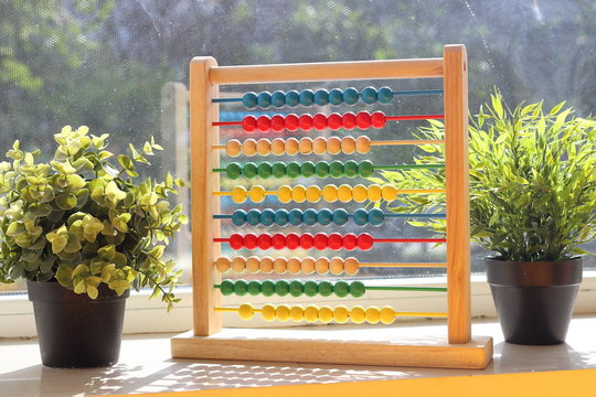 Educational colorful children's accounts (abacus) on the windowsill
