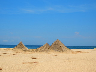 Fototapeta na wymiar pyramid from sand by the beach