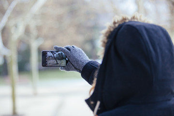 close up of a phone taking a photo outside in the park