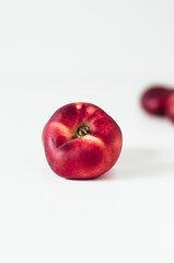Selective focus composition of several fresh flat donut nectarines, red saturn nectarines or ripe...