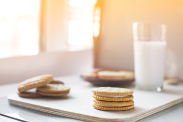 miscellaneous cookies, next to milk on a soft light background