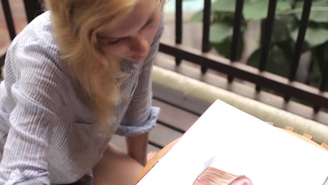 female draws a capkake in the album