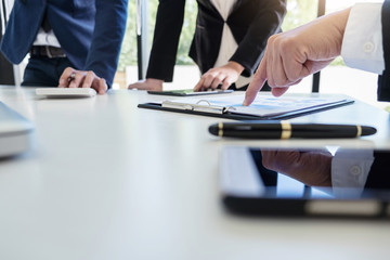 Teamwork process, Business team managers colleagues discussing and analysis new plan financial graph data and marketing documents report on office table with laptop and digital tablet