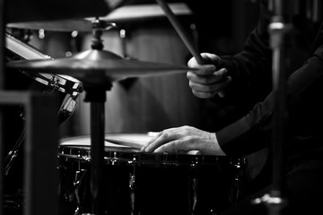  Human hands playing the drum kit in black and white