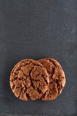 Chocolate chips cookies isolated on black background, macro, close-up, vertical