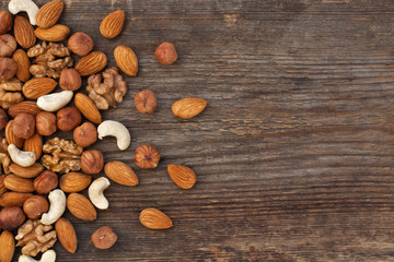  Different nuts on a wooden background