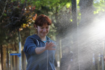 girl playing water in the garden