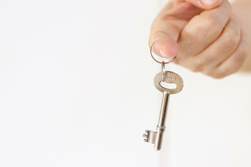 Hand holding key.