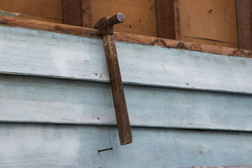 Hammer is hang on the wall wood.