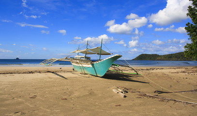 A traditional Philippine boat on the beach of Nagtabon. The island of Palawan. Philippines.
