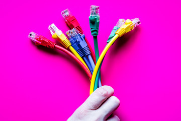 concept network internet cable on pink background close up