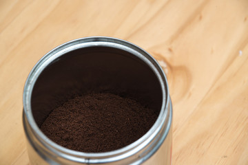 Coffee grounds in a white cup on  a wooden table for breakfast