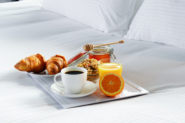 Breakfast in bed in hotel room.