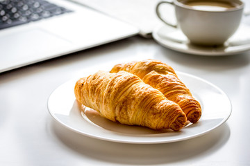 Office breakfast with laptop on white desk