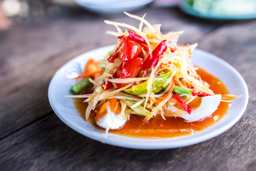 Papaya salad with salted egg on the plate, Traditional Thai food.save paths.