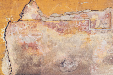 Old colored concrete wall with cracks and chipped, texture