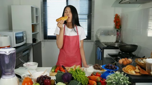 4k of woman eating a bread in kichen room at home