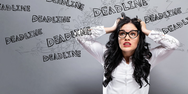 Deadline with young business woman feeling stressed