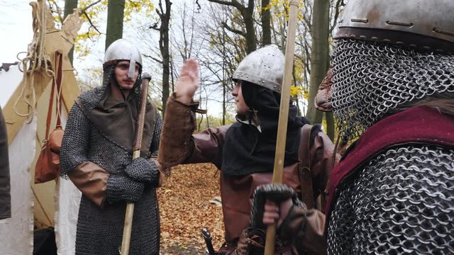 A group of Vikings in the woods discusses a hike