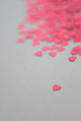 Red and pink glitter hearts on white background. Selective focus. Valentine´s Day.
