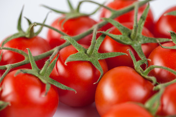 Bunch of red tasty fresh tomatos on the white background