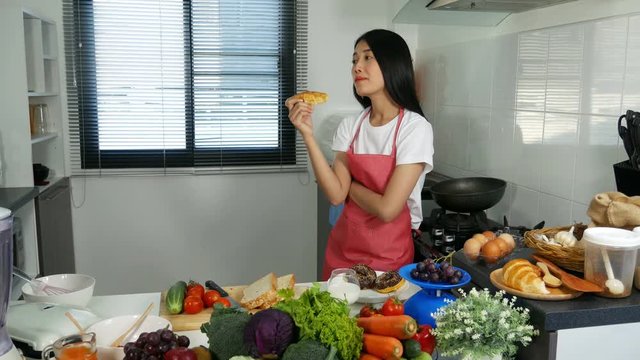 4k of woman eating a bread in kichen room at home