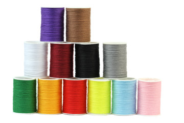 Colorful thread spools isolated on white background.
