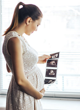 Pregnant Girl With Ultrasound Result In Hands