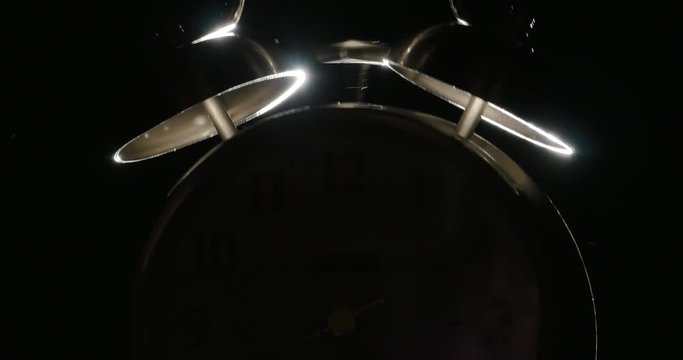 Twin Bell Alarm Clock Ringing Isolated on Black