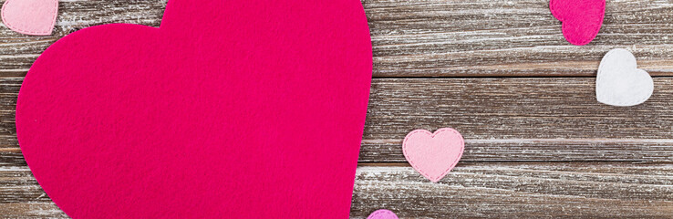Valentines Day Background Card with Fabric Hearts over Wooden Background. Selective focus.