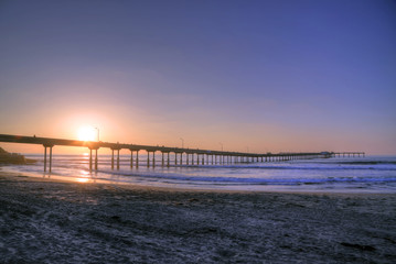 Fototapeta premium The sunset over the Ocean Beach Pier near San Diego, California.