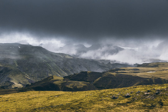 Drama icelandic landscape with steaming hills.