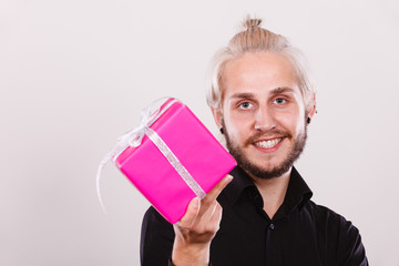 man holding present pink gift box in hand