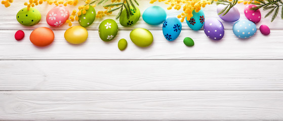 Easter Eggs with Flowers On Wood Background