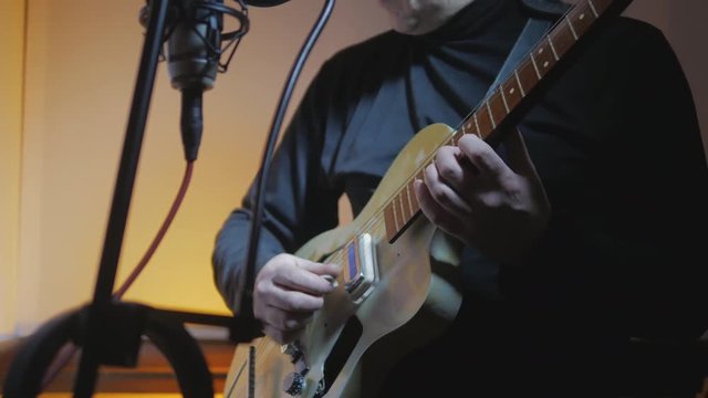 4k Guitarist plays rockabilly music by electric vintage guitar at music studio