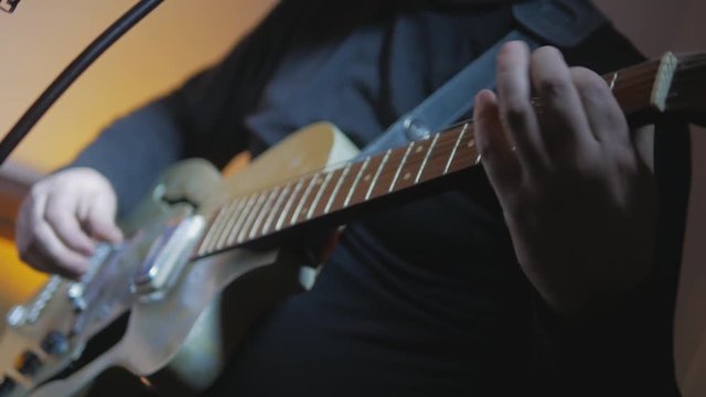 4k Rocker playing by vintage guitar during record at the studio