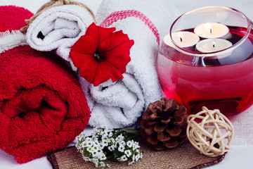 Obraz na płótnie Canvas SPA consist from towels, candles, flowers, and aromatherapy