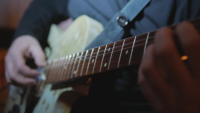 4k Musician playing rockabilly songs by vintage electric guitar at the studio
