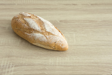 CRUSTY LOAF BREAD ON WOOD TABLE
Baked brown crusty french bread, a whole loaf on the wood table.