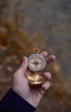 Hand with compass in nature