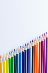 Several colored pencils on a white background with copy space