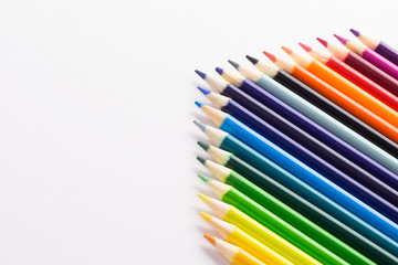 Several colored pencils on a white background with copy space