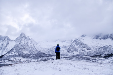 Fototapeta na wymiar Person Looking Out onto Snowy Landscape