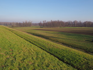 Fototapeta na wymiar Countryside landscape of green grassy field next to artificial Goczalkowice Reservoir in Poland